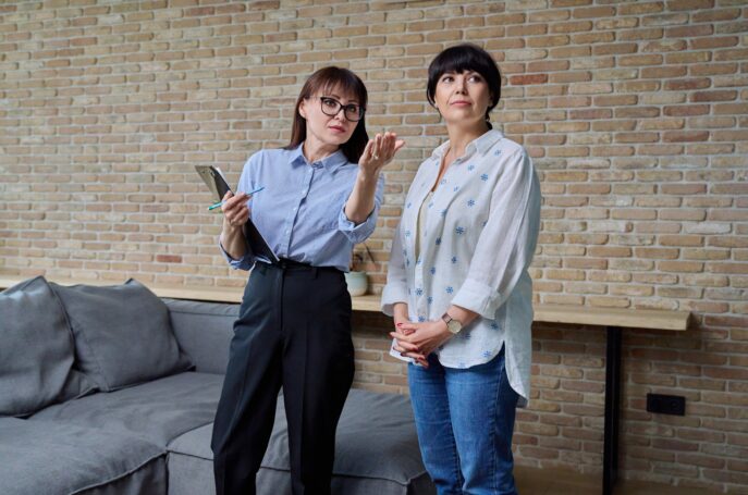 Female real estate agent showing apartment, house, to buyer, tenant